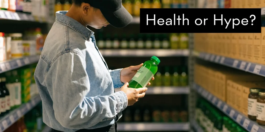 Person in a grocery aisle examining a green drink bottle, with “Health or Hype?” text overlay