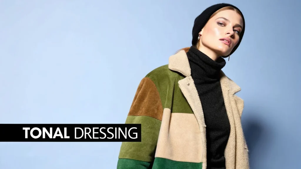 Woman in layered autumn outfit with beanie and coat, text “Tonal Dressing” displayed