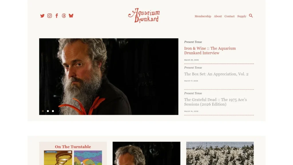 Aquarium Drunkard homepage featuring bearded man portrait and music interview articles list