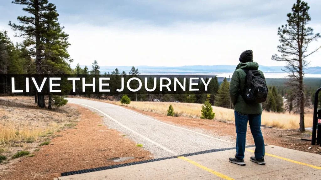 Hiker with backpack overlooking winding road and forest landscape, text “Live the Journey.”