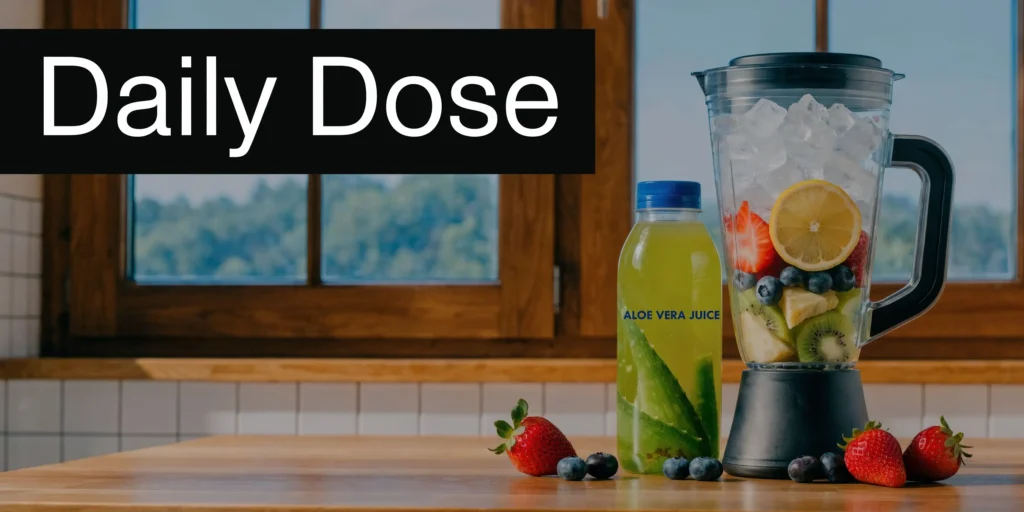 Blender with fruit and ice beside aloe vera juice bottle on kitchen counter, labeled “Daily Dose”