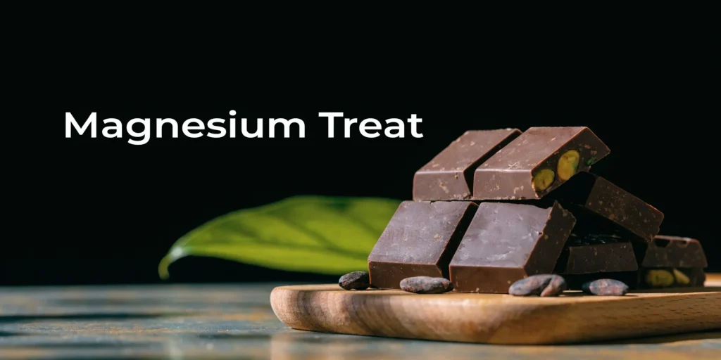 10 Cortisol Lowering Foods for Your 2026 Diet Plan Dark chocolate pieces with cocoa beans and “Magnesium Treat” text on a wooden tray against a black background.