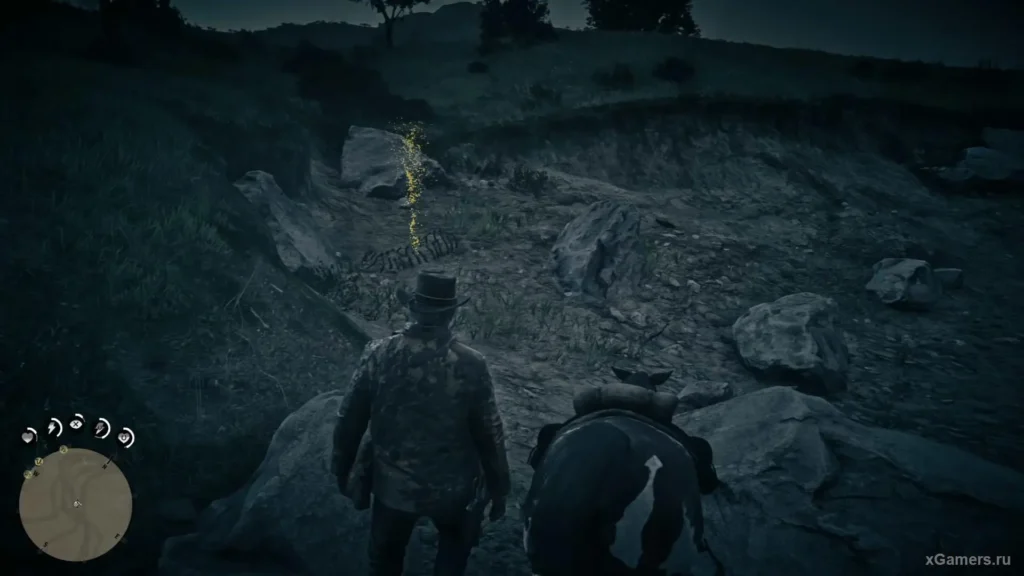 Cowboy and horse investigate glowing dinosaur bones at night in a rocky Red Dead Redemption 2 landscape.
