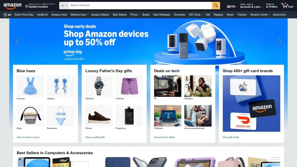 Amazon homepage featuring Prime Day deals, tech offers, gift cards, and product categories in a desktop browser.