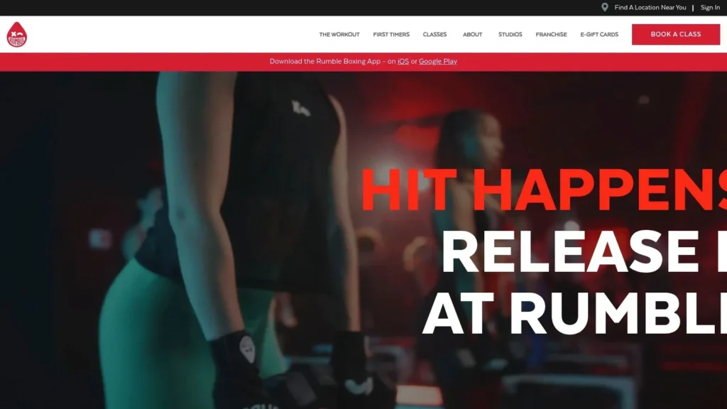 The 7 Best Exercise Classes NYC Has to Offer in 2026 Rumble Boxing homepage with workout class promotion, athletes training, and bold “Hit Happens” fitness slogan.