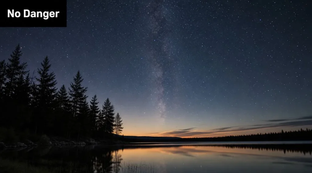 Starry night sky over a calm lake and forest silhouette, illustrating a safe view of the cosmos and Milky Way.